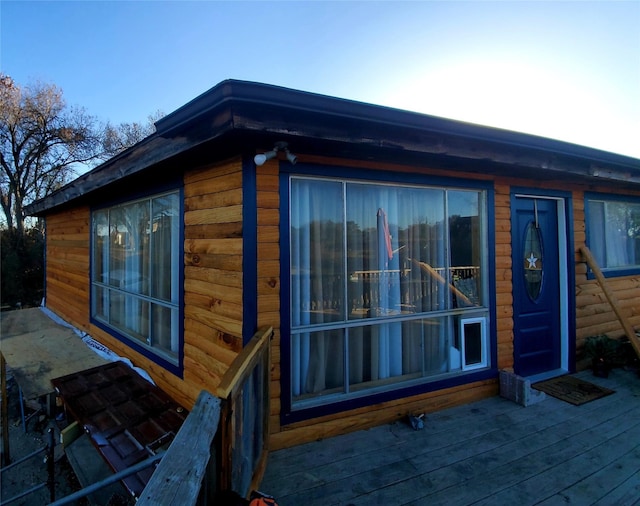 view of property exterior featuring a wooden deck