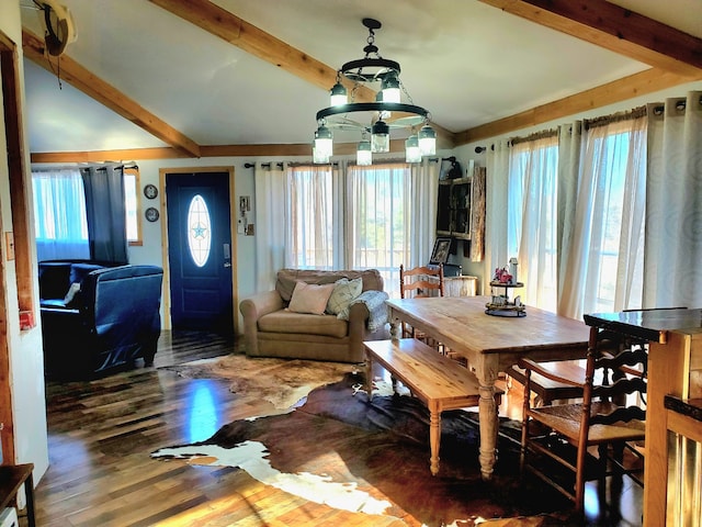 dining area with dark wood-type flooring and lofted ceiling with beams