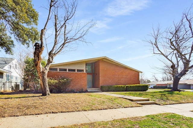 view of property exterior with a yard and central AC unit