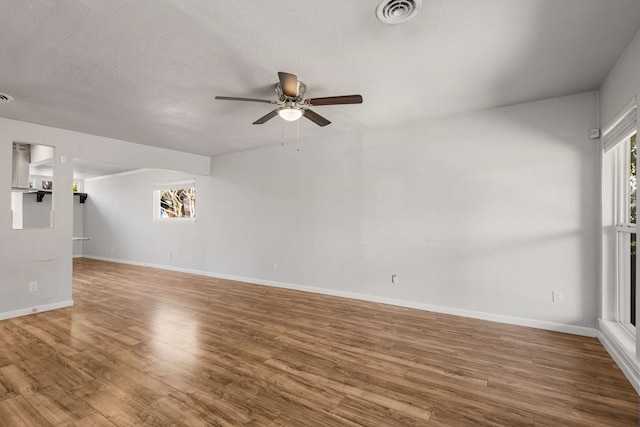 unfurnished living room featuring hardwood / wood-style floors, a textured ceiling, and ceiling fan