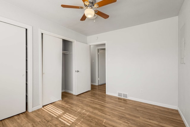 unfurnished bedroom featuring hardwood / wood-style flooring and ceiling fan