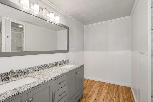 bathroom with vanity, hardwood / wood-style floors, and ornamental molding