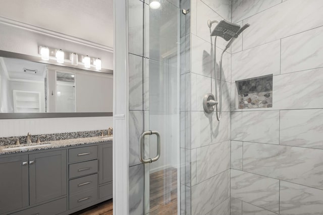 bathroom featuring vanity and a shower with shower door