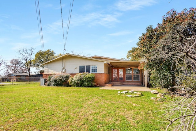 back of house featuring a patio, cooling unit, and a lawn