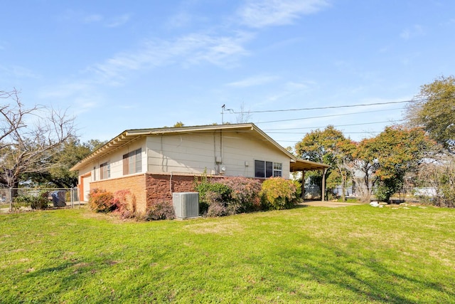 view of side of property with central AC and a lawn