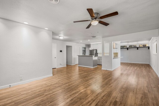 spare room with hardwood / wood-style floors and a textured ceiling