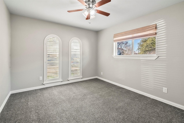 unfurnished room featuring dark carpet and ceiling fan