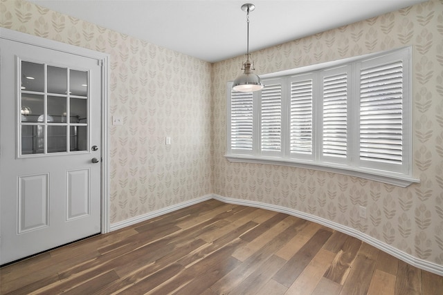 unfurnished dining area featuring dark wood-type flooring