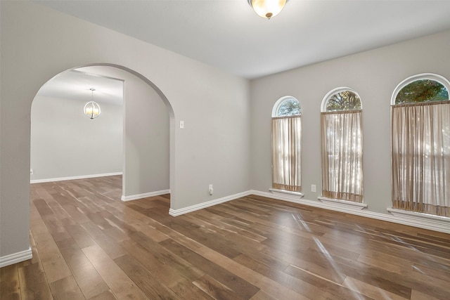 unfurnished room featuring dark hardwood / wood-style flooring