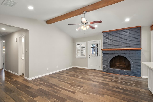 unfurnished living room with dark hardwood / wood-style flooring, a fireplace, lofted ceiling with beams, and ceiling fan