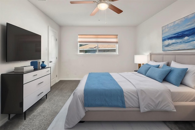 bedroom featuring dark colored carpet and ceiling fan