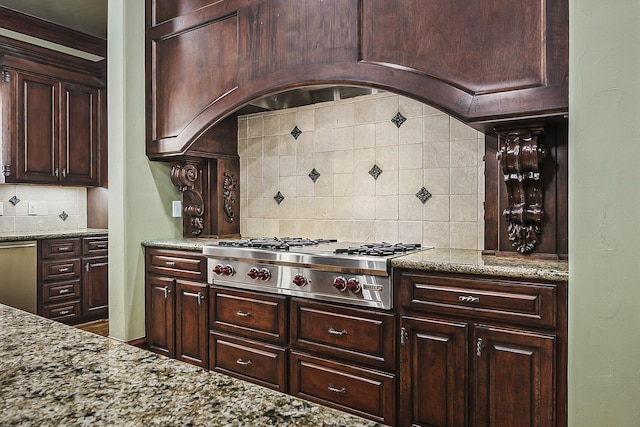 kitchen featuring light stone counters, tasteful backsplash, dark brown cabinetry, and stainless steel gas cooktop