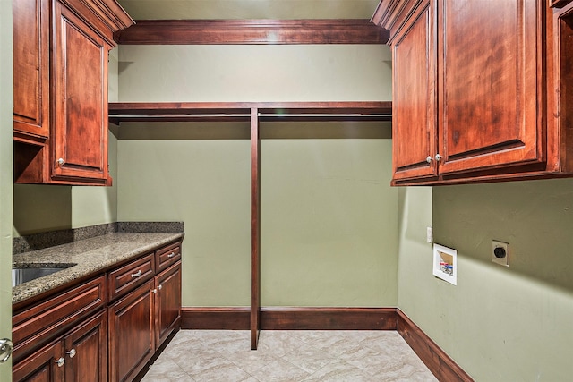 laundry room with cabinets, washer hookup, sink, and hookup for an electric dryer