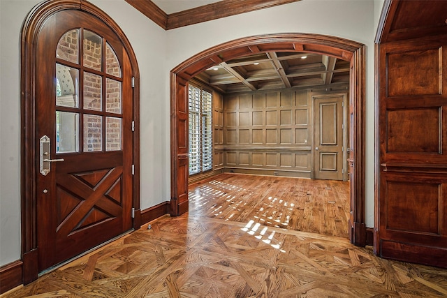 foyer entrance featuring beamed ceiling, ornamental molding, parquet flooring, and coffered ceiling