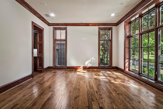 unfurnished room featuring wood-type flooring and crown molding