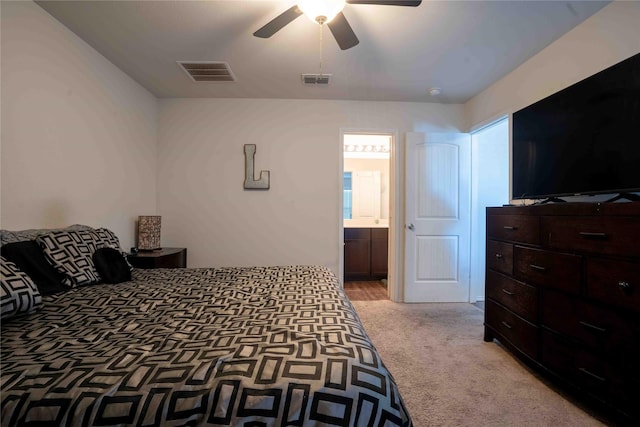 carpeted bedroom featuring ceiling fan and ensuite bathroom