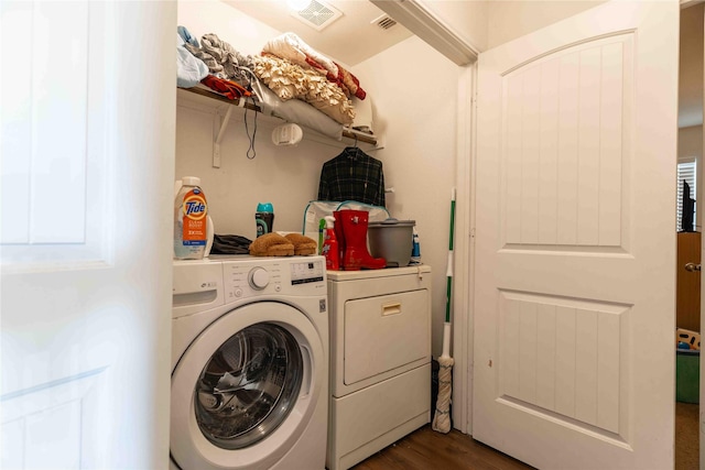 laundry area featuring dark wood-type flooring and washing machine and clothes dryer