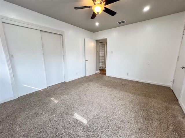 unfurnished bedroom with a closet, ceiling fan, and carpet