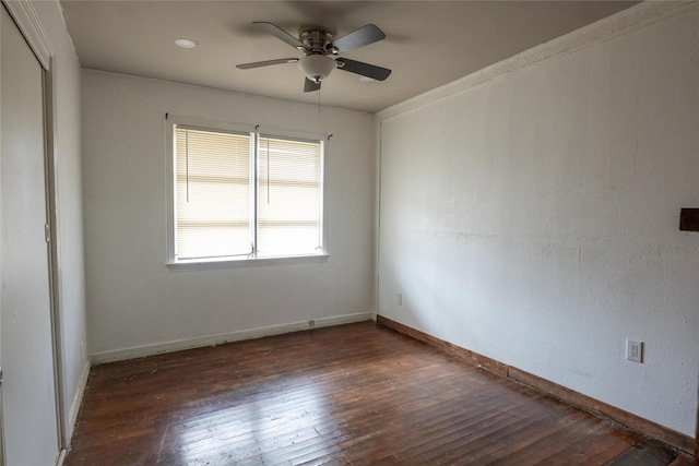 unfurnished room featuring dark wood-type flooring and ceiling fan