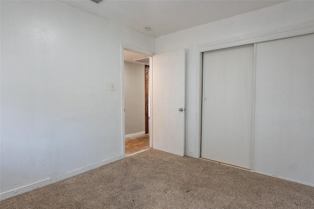 unfurnished bedroom with a closet and carpet