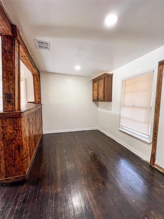 unfurnished living room with dark hardwood / wood-style floors