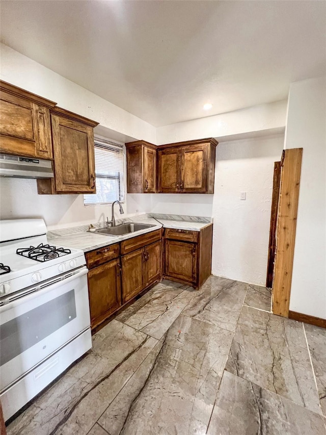 kitchen with white range with gas cooktop and sink