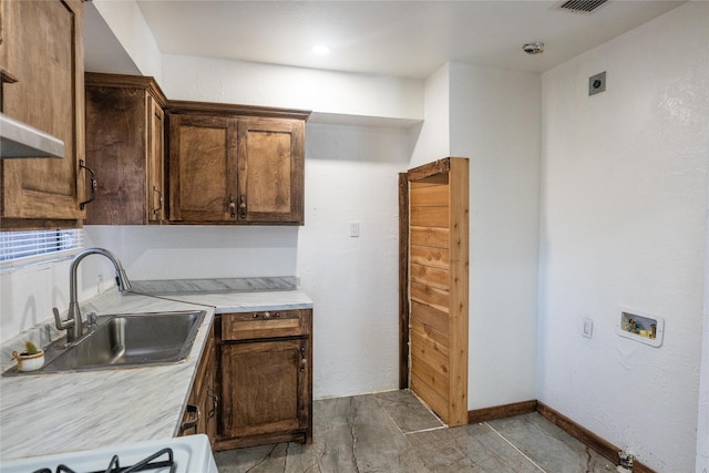 kitchen featuring stove and sink