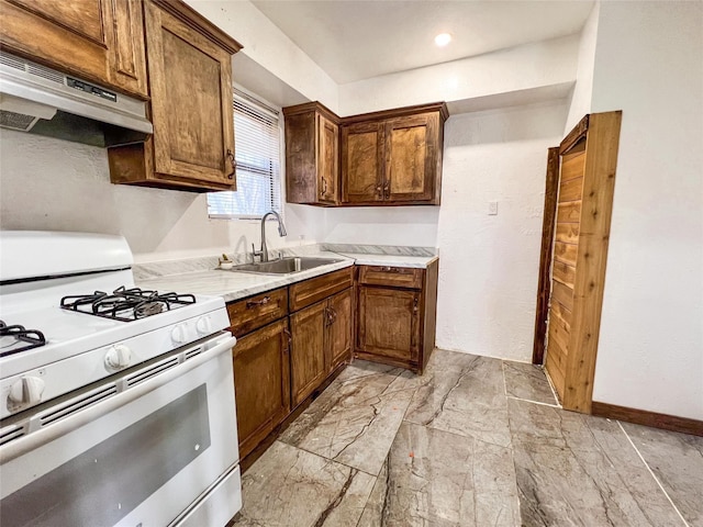 kitchen featuring sink and white gas stove