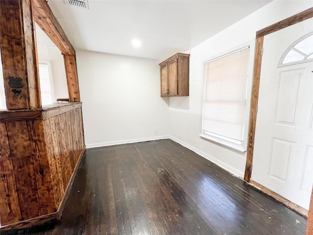 unfurnished dining area with dark hardwood / wood-style flooring