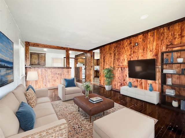 living room with hardwood / wood-style flooring and wooden walls