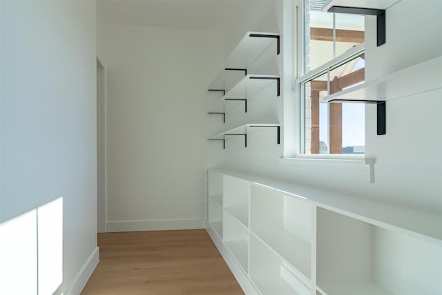 spacious closet with light hardwood / wood-style flooring