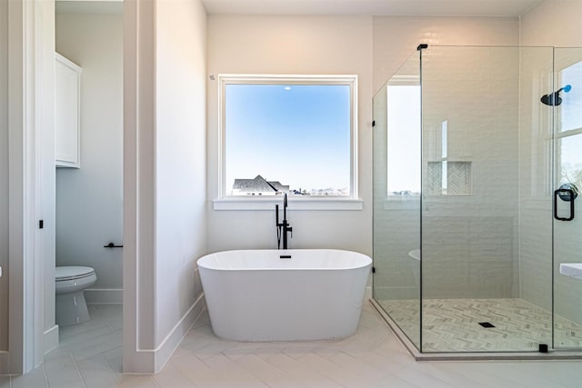 bathroom with shower with separate bathtub and toilet