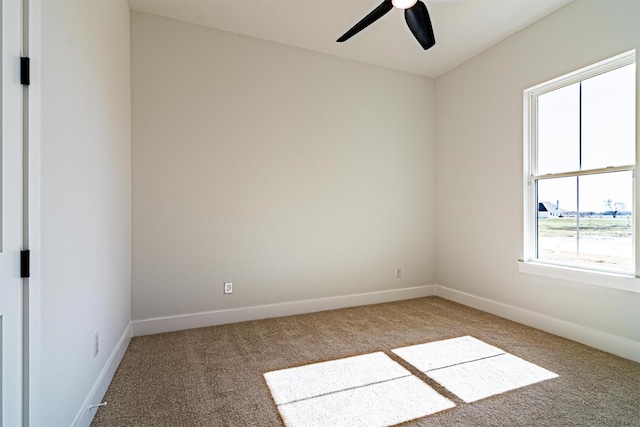 empty room with ceiling fan and carpet floors