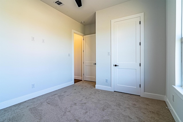 unfurnished bedroom with ceiling fan and carpet