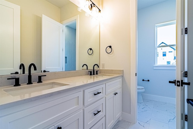 bathroom featuring vanity and toilet