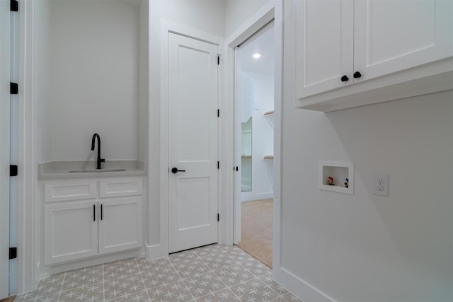 laundry room featuring cabinets, washer hookup, and sink