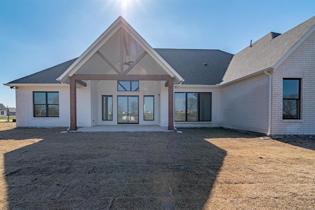 rear view of house with a patio, a yard, and ceiling fan