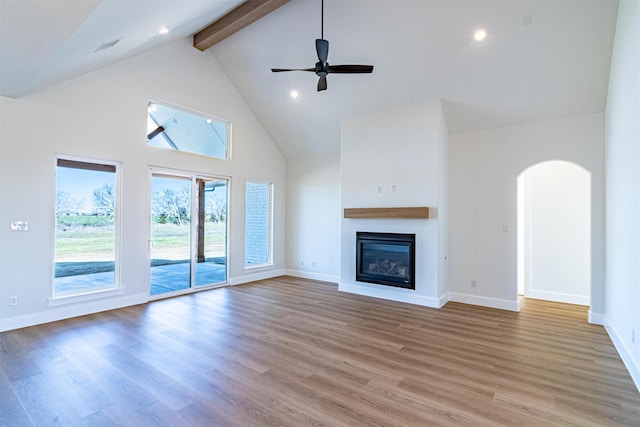 unfurnished living room featuring beam ceiling, high vaulted ceiling, ceiling fan, and hardwood / wood-style flooring