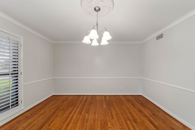 unfurnished room with a notable chandelier, crown molding, and hardwood / wood-style floors