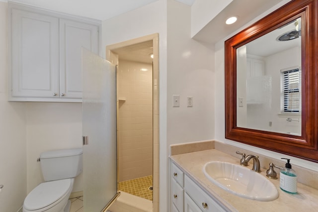 bathroom with vanity, a shower with door, and toilet