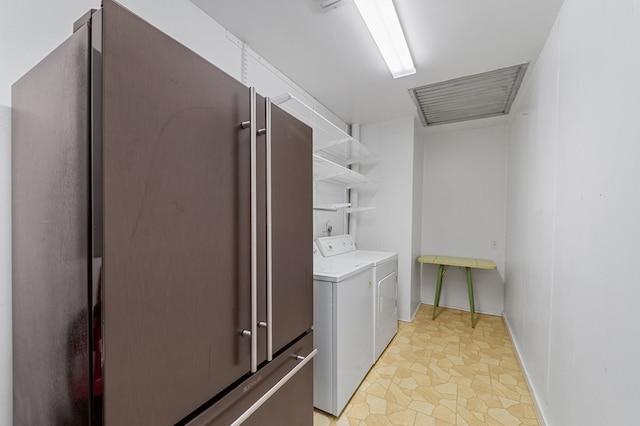 clothes washing area featuring washer and clothes dryer