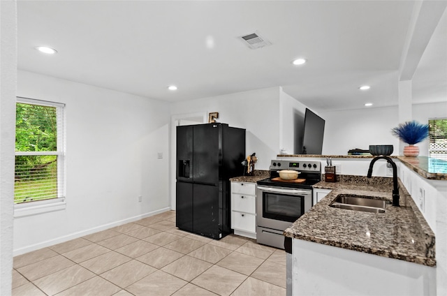 420 S Evans St, Boyd, TX 76023 - kitchen featuring electric range, black fridge, a sink, dark stone countertops, and white cabinetry