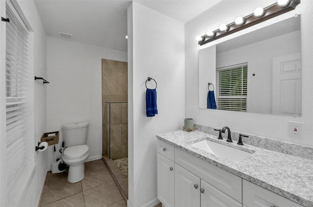 420 S Evans St, Boyd, TX 76023 - bathroom with toilet, tiled shower, tile patterned floors, and vanity