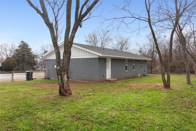 view of side of home featuring a lawn