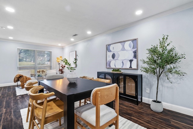 dining room featuring dark wood-type flooring and ornamental molding