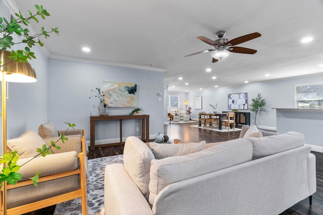 living room featuring ornamental molding, ceiling fan, and dark hardwood / wood-style flooring