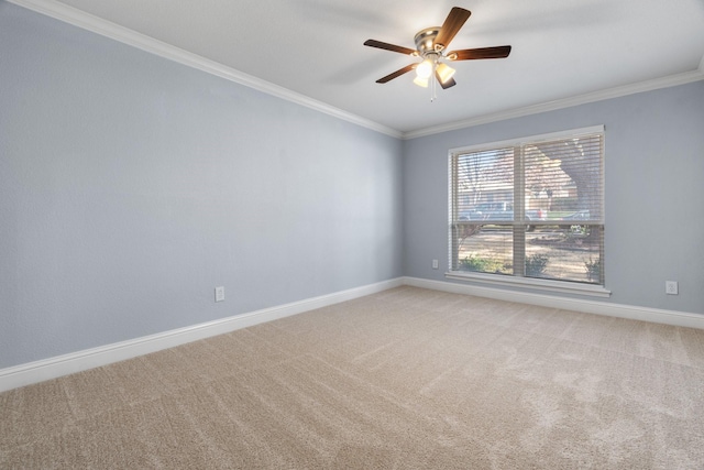 empty room featuring crown molding, light colored carpet, and ceiling fan