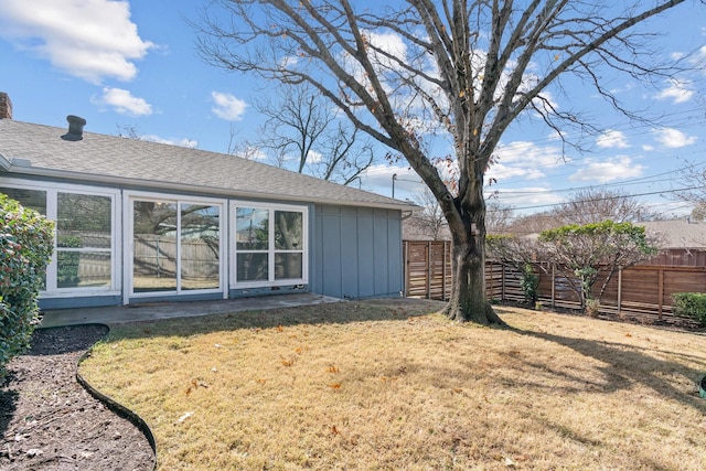 rear view of property featuring a lawn