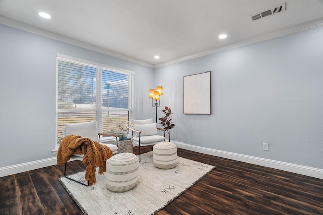 sitting room featuring ornamental molding and dark hardwood / wood-style floors