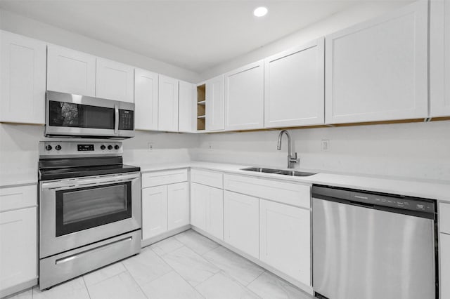 kitchen featuring stainless steel appliances, sink, and white cabinets